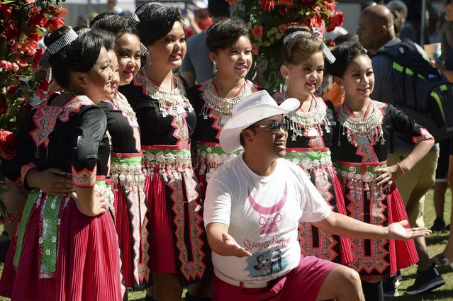 Founder and organizer Tou Ger Xiong, front, poses with a group of Hmong dancers during Hmong Minnesota Day at the Minnesota State Fair, September 6, 2021, in Falcon Heights, Minn. On Wednesday, Dec. 13, 2023, Colombian authorities were investigating the alleged kidnapping and murder of the Hmong American comedian and activist Xiong, who was found dead Monday, Dec. 11, in a wooded area of the northern city Medellín. (Photo by Scott Takushi/Pioneer Press via AP Photo)