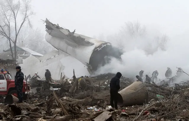 Rescue teams are seen at the crash site of a Turkish cargo jet near Kyrgyzstan's Manas airport outside Bishkek, January 16, 2017. (Photo by Vladimir Pirogov/Reuters)