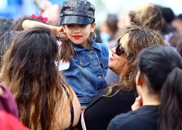 Melanie Vela, 7, wears clothing inspired by Selena during the second day of Fiesta de la Flor: A celebration of the Life & Legacy of Selena on Saturday, April 18, 2015, at North Bayfront Park in Corpus Christi, Texas. (Photo by Gabe Hernandez/Corpus Christi Caller-Times via AP Photo)