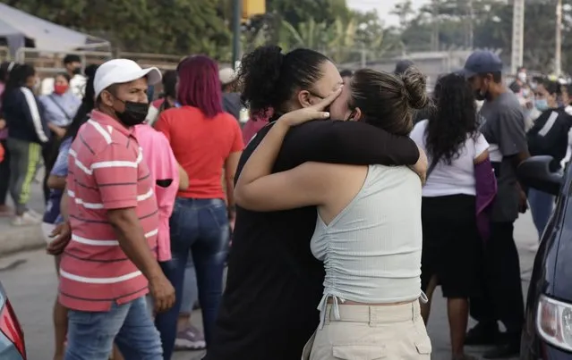 Women hug while waiting for some information about their relatives who are inmates at Litoral Penitentiary, after a prison riot, in Guayaquil, Ecuador, Wednesday, September 29, 2021. The authorities report at least 100 dead and 52 injured in the riot on Tuesday at the prison. (Photo by Angel DeJesus/AP Photo)