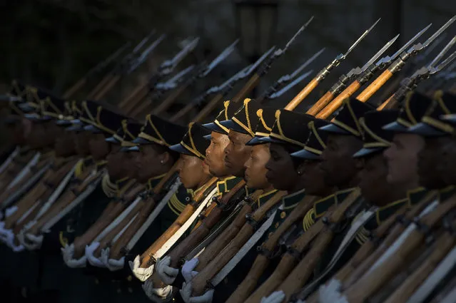 Members of the honour guard from the South African National Defence Force stands guard as South African president arrives at the South African Parliament, to deliver the 2017 State Of the Nation Address (SONA), and formally open Parliament for the year, on February 9, 2017, in Cape Town. A violent brawl broke out in South Africa's parliament on February 9, 2017 as guards exchanged punches with opposition lawmakers who had shouted down President Jacob Zuma as he tried to deliver his state of the nation address. In chaotic scenes, about 30 guards dressed in white shirts forcibly ejected about 25 members from the radical leftist Economic Freedom Fighters (EFF) party who had prevented the president from speaking for about an hour. (Photo by Rodger Bosch/AFP Photo)