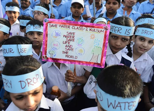 Indian school children take part in an awareness rally held to mark World Water Day in Hyderabad on March 22, 2016. The United Nations World Water Day is marked anually on March 22 and in 2016 focuses on the positive impact water quantity and quality can have on workers' lives and livelihoods, and societies and economies. (Photo by Noah Seelam/AFP Photo)