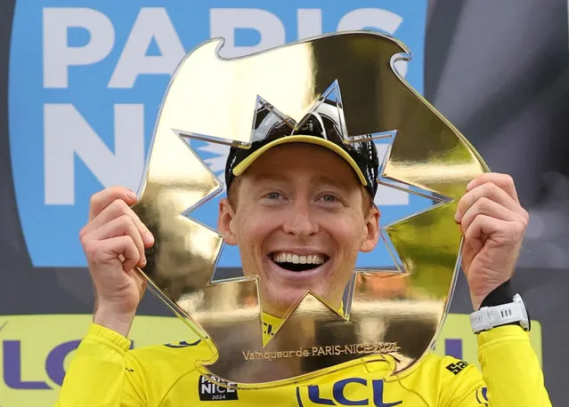 First placed Team Visma-Lease a Bike's US cyclist Matteo Jorgenson poses with the trophy on the podium after winning the 82nd edition of the Paris-Nice cycling race, on March 10, 2024. (Photo by Thomas Samson/AFP Photo)