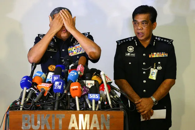Malaysia's Royal Police Chief Khalid Abu Bakar demonstrates to the media during a news conference regarding the apparent assassination of Kim Jong Nam, the half-brother of the North Korean leader, at the Malaysian police headquarters in Kuala Lumpur, Malaysia, February 22, 2017. (Photo by Athit Perawongmetha/Reuters)
