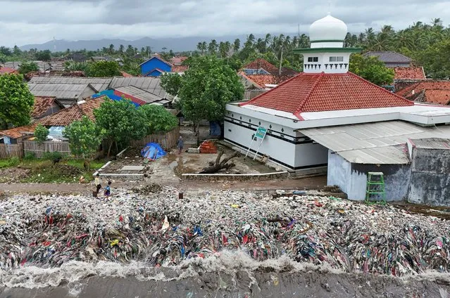 A drone view shows trash being swept to the shore due to high tides caused by erratic weather, on a beach in Teluk fishing village, in Pandeglang regency, Banten province, Indonesia, on March 15, 2024. (Photo by Willy Kurniawan/Reuters)