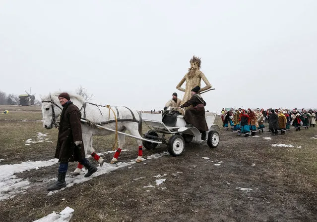 Revellers lead a cart with an effigy of Kostrubatyi Did, a symbol of winter, during the celebration of Maslenitsa also known as Kolodiy, a pagan holiday marking the end of winter, in Kiev, Ukraine, February 26, 2017. (Photo by Vasily Fedosenko/Reuters)