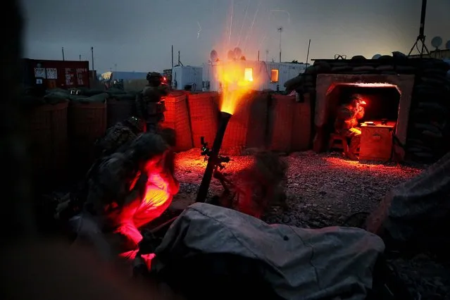 Soldiers with the U.S. Army's 3rd Brigade Combat Team, 10th Mountain Division fire a mortar round during a training exercise on FOB Lightning near Gardez, Afghanistan, on March 21, 2014. (Photo by Scott Olson/Getty Images)