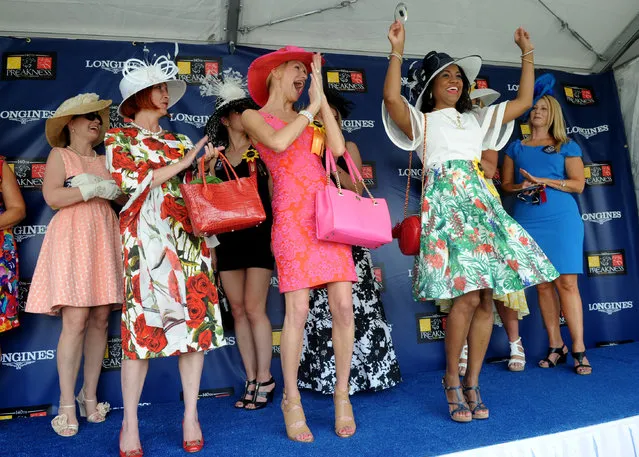 Katrina Dennis, right, of Baltimore, Md., celebrates after winning the Longines Most Elegant Woman at the Preakness contest, Saturday, May 16, 2015, at Pimlico Race Course in Baltimore, Md. Longines, the Swiss watch manufacturer known for its elegant timepieces, is the Official Watch and Timekeeper of the 140th annual Preakness Stakes and the Triple Crown. (Photo by Diane Bondareff/Invision for Longines/AP Images)
