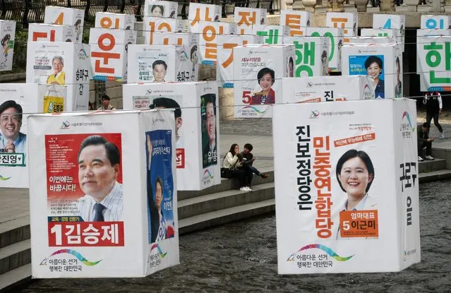 Election posters promoting candidates for Seoul's parliamentary election are hung on string over the Cheonggye Stream in Seoul, South Korea, April 13, 2016. (Photo by Ahn Young-joon/AP Photo)