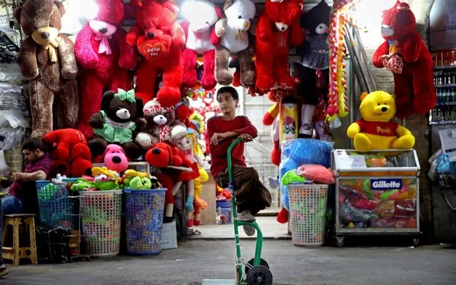 A young worker sits on his hand cart at the old main bazaar in Tehran, Iran, Wednesday, May 8, 2019. After the U.S. withdrew from the the 2015 nuclear deal it restored crippling sanctions on Iran, exacerbating a severe economic crisis. The Iranian rial, which traded at 32,000 to $1 at the time of the accord, traded Wednesday at 153,500. (Photo by Ebrahim Noroozi/AP Photo)