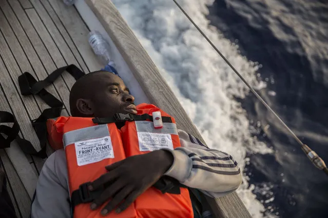 A migrant rests on a Mediterranea Saving Humans NGO boat, as they sail off Italy's southernmost island of Lampedusa, just outside Italian territorial waters, on Thursday, July 4, 2019. An Italian humanitarian group whose boat has been barred from docking in Lampedusa said the health of the 54 migrants it rescued at sea is rapidly deteriorating, prompting fears of another standoff with Italy's populist government. Mediterranea Saving Humans said Friday in a tweet that its sailing boat ALEX was off Italy's southernmost island of Lampedusa, just outside Italian territorial waters, and that it has been banned from entering Italian jurisdiction by ministerial decree. (Photo by Olmo Calvo/AP Photo)