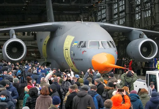 People surround a new military transport aircraft Аn-178-100R designed for the Ukrainian Armed Forces during its roll-out at the Antonov aircraft plant in Kyiv Ukraine, December 28, 2021. (Photo by Gleb Garanich/Reuters)