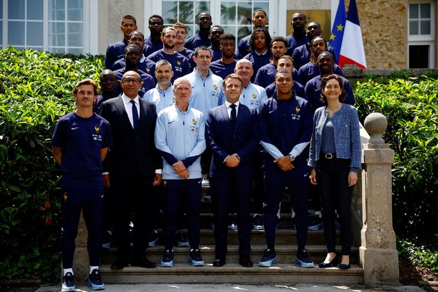 French President Emmanuel Macron (front C) poses with French headcoach Didier Deschamps (front C-L), French Football Federation President Philippe Diallo (front 2L), France's Minister for Sports and Olympics Amelie Oudea-Castera (front R) and French football players as part of the team's preparation for the UEFA Euro 2024 European football championships in Clairefontaine-en-Yvelines on June 3, 2024. (Photo by Sarah Meyssonnier/Pool via AFP Photo)