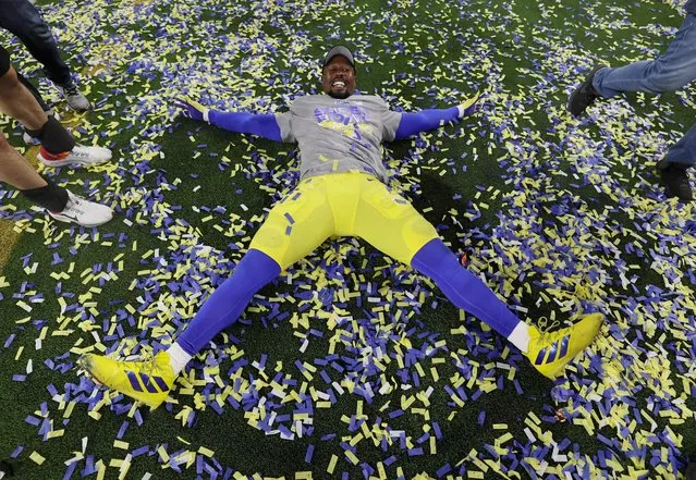 Von Miller of the Los Angeles Rams celebrates with making a confetti angel on the field after the Rams defeat the Cincinnati Bengals 23-20 in an NFL Super Bowl LVI football game at SoFi Stadium in Inglewood, on Sunday, February 13, 2022. (Photo by Mike Segar/Reuters)