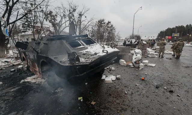 A damaged Ukrainian armored vehicle in the aftermath of an overnight shelling at the Ukrainian checkpoint in Brovary near Kiev (Kyiv), Ukraine, 01 March 2022. (Photo by Sergey Dolzhenko/EPA/EFE)