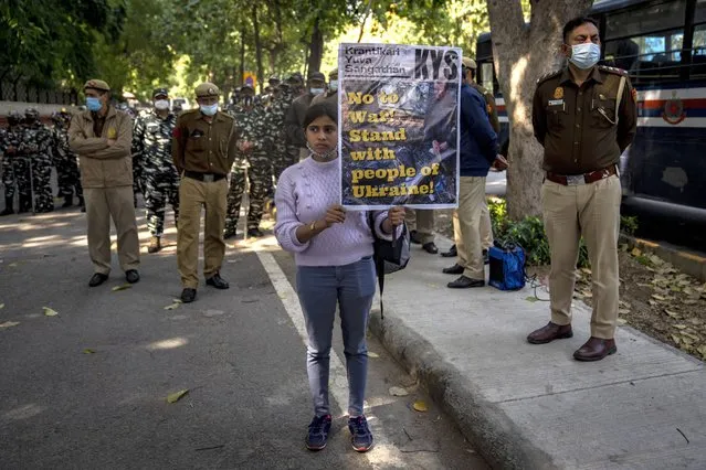 A student activist holds a placard during a protest against Russian offensive on Ukraine, in New Delhi, India, Saturday, February 26, 2022. As the fighting continued in Ukraine, several organizations held protest demonstrations in the Indian capital for a second day on Saturday, demanding an end to the Russian aggression and pressing the Indian government to evacuate thousands of Indians, mostly students, stranded there. (Photo by Altaf Qadri/AP Photo)