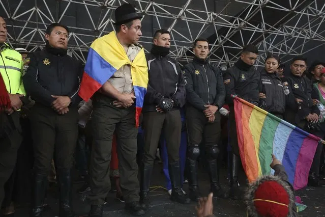 Police detained by anti-governments protesters are presented on a stage in Quito, Ecuador, Thursday, October 10, 2019. Thousands of protesters staged anti-government rallies Wednesday, seeking to intensify pressure on Ecuador's president after a week of unrest sparked by fuel price hikes. (Photo by Fernando Vergara/AP Photo)