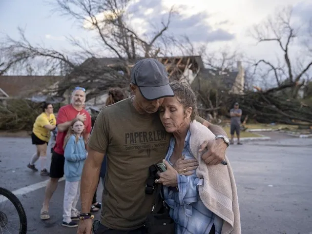Michael Talamantez comforts his girlfriend Derry Schroer after Talamantez' house on Stratford Drive in Round Rock, Texas was destroyed by a severe storm, reported as a tornado, while they were inside on Monday March 21, 2022. “I thought I was going to die”, he said. (Photo by Jay Janner/Austin American-Statesman via AP Photo)