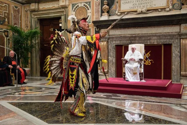 This photo taken and handout on April 01, 2022 shows a delegation member chant and dance before Pope Francis during an audience to Canada's Indigenous delegations at the Vatican. Pope Francis on April 01 apologised for the decades of abuse at church-run residential schools in Canada and said he would visit the country in late July. (Photo by Vatican Media /Handout via AFP Photo)