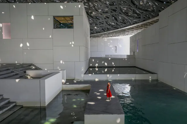 A visitor walks through a patch of light at the Louvre Abu Dhabi Museum in Abu Dhabi, United Arab Emirates on October 27, 2019. (Photo by Christopher Pike/Reuters)