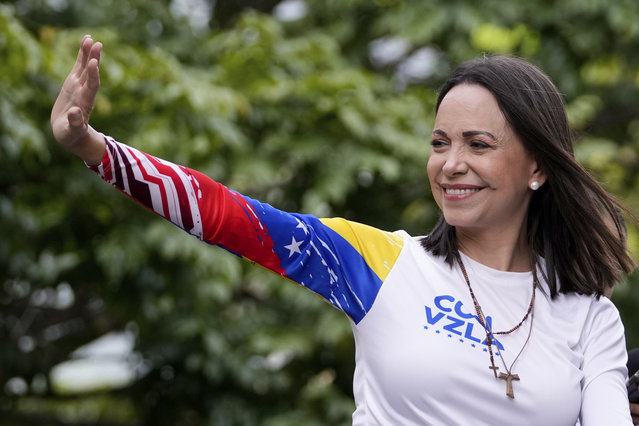 Opposition leader Maria Corina Machado waves from atop a truck during the closing election campaign rally for presidential candidate Edmundo Gonzalez in Caracas, Venezuela, Thursday, July 25, 2024. The presidential election is set for July 28. (Photo by Matias Delacroix/AP Photo)