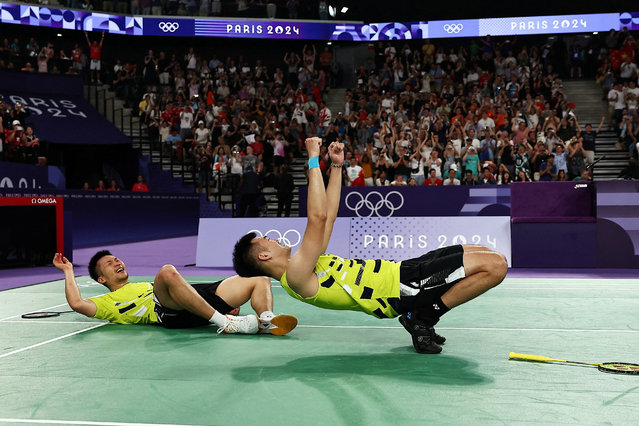 Taiwan's Lee Yang and Wang Chi-lin celebrate winning the men's doubles badminton final match against China during the Paris 2024 Olympic Games at Porte de la Chapelle Arena in Paris on August 4, 2024. (Photo by Ann Wang/Reuters)