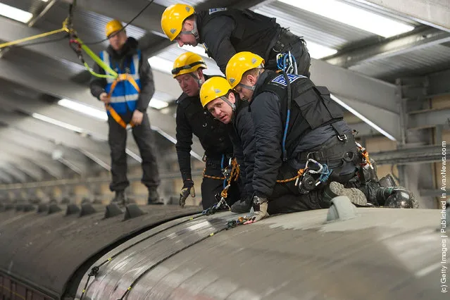 Police take part in a role play exercise as they clear a protest on top of a train during training in Oxenhope, England