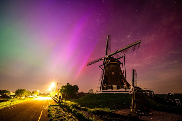 The Northern lights (aurora borealis) lights up the night sky above the Molenviergang in Aarlanderveen, the Netherlands, early on 11 May 2024. The National Oceanic and Atmospheric Administration (NOAA) of America has warned that the strongest geomagnetic storm for 20 years is set to hit Earth, making the Aurora Borealis, or Northern Lights, visible at much lower geomagnetic latitudes than usual. (Photo by Josh Walet/EPA/EFE/Rex Features/Shutterstock)