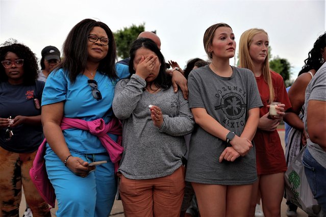 (L-R) Therese Badiki, Adriana Rosales, Marley Hall, and Addie Bell stand together during a vigil next to a memorial next to the Allen Premium Outlets on May 7, 2023 in Allen, Texas. The memorial is for the victims of the mass shooting in the Allen Premium Outlets mall on May 6th. According to reports, a shooter opened fire at the outlet mall, killing eight people. The gunman was then killed by an Allen Police officer that was responding to an unrelated call. (Photo by Joe Raedle/Getty Images)