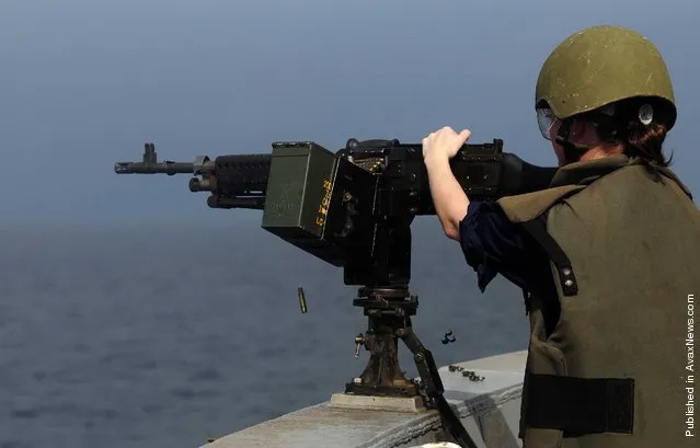 Information Systems Technician 2nd Class Elise Hicks participates in a live-fire training exercise aboard the San Antonio-class amphibious transport dock ship USS Mesa Verde (LPD 19)