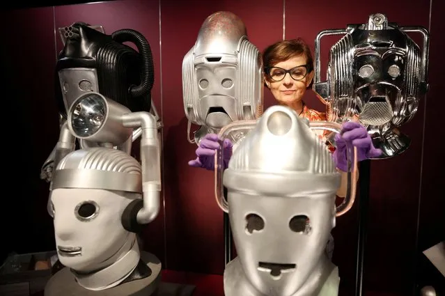 Sculpture conservator Marisa Prandelli adjusts a display of heads of “Cybermen” in the monster vault at the “Doctor Who: Worlds of Wonder” exhibition which opens at the World Museum later this month in Liverpool, Britain, May 19, 2022. (Photo by Phil Noble/Reuters)
