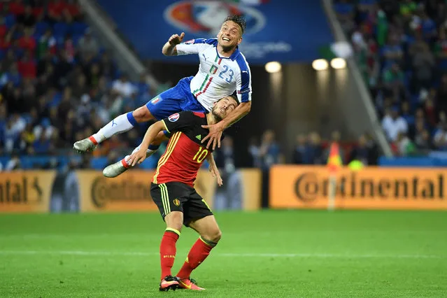 Italy's midfielder Emanuele Giaccherini (up) vies with Belgium's forward Eden Hazard during the Euro 2016 group E football match between Belgium and Italy at the Parc Olympique Lyonnais stadium in Lyon on June 13, 2016. (Photo by Emmanuel Dunand/AFP Photo)