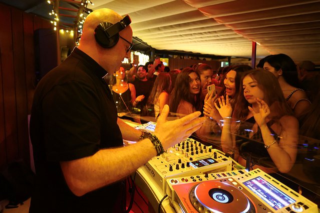 DJ priest Guilherme plays music in the parish bar of Laundos, Povoa do Varzim, Portugal, on July 13, 2024. (Photo by Pedro Nunes/Reuters)