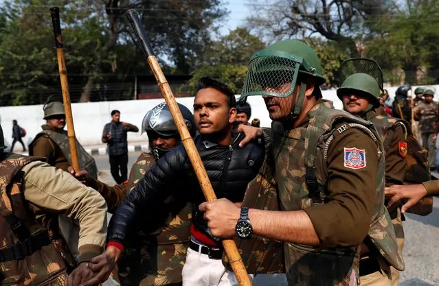 Police detain an unidentified man after he brandished a gun and injured a student during a protest against a new citizenship law outside the Jamia Millia Islamia university in New Delhi, India, January 30, 2020. Minutes before firing, the shooter, who identified himself as “Rambhakt Gopal” had uploaded posts onto his Facebook profile saying this will be his “final journey” and urging readers to “remember his family”. His video showed him walking through a road near Jamia, where the students were gathering. On his Facebook the shooter had also posted photos of himself posing with a gun and he is seen wearing a saffron T-shirt, the color of Hindu nationalists. (Photo by Danish Siddiqui/Reuters)