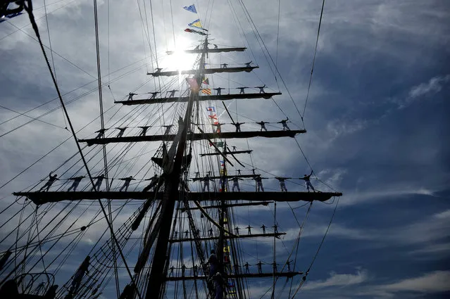 Sailors stand in the rigging of the ARM Cuauhtemoc, a training vessel for the Mexican Navy, as it heads to the Inner Harbor as part of the Star-Spangled Sailabration