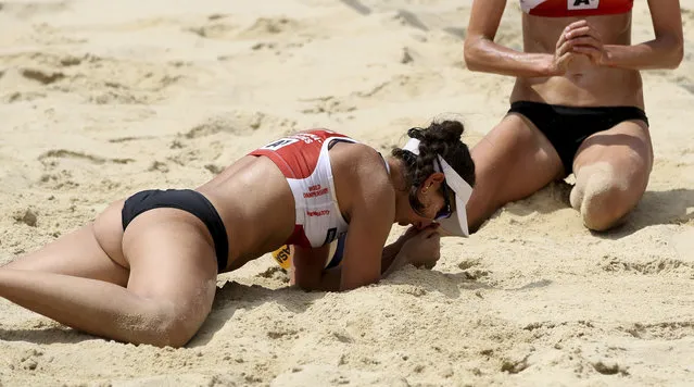 Canada's Melissa Humana-Paredes and Sarah Pavan, from left, react during the women's quarter final match against Canada's team at the Beach Volleyball World Championships in Vienna, Austria, Friday, August 4, 2017. (Photo by Ronald Zak/AP Photo)