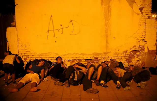 Immigrants sleep at Gevgelija railway station, Macedonia August 19, 2015. (Photo by Ognen Teofilovski/Reuters)