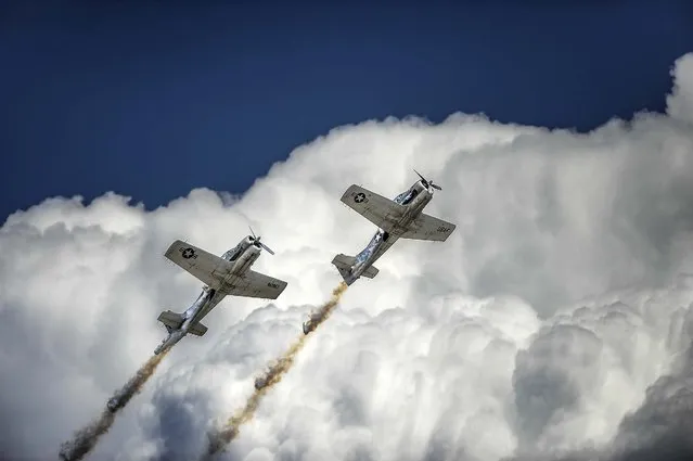 The Trojan Phlyers Air Race & Airshow Team perform in their restored T-28B aircraft at the Colorado Springs Airport for the Pikes Peak Regional Air Show, on August 9, 2014. (Photo by Michael Ciaglo/The Colorado Springs Gazette)