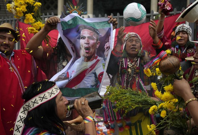 Peruvian shamans hold a photo of Peru's soccer player Paolo Guerrero during a good luck ritual for the national team outside the National Stadium in Lima, Peru, Monday, September 11, 2023. Peru will face Brazil in a World Cup 2026 qualifying soccer match in Lima on Sept. 12. (Photo by Martin Mejia/AP Photo)