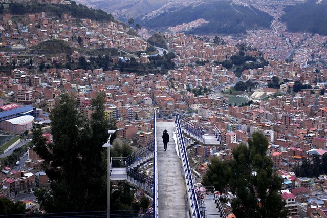 A woman traverses a bridge in La Paz, Bolivia, Wednesday, November 27, 2024. (Photo by Juan Karita/AP Photo)