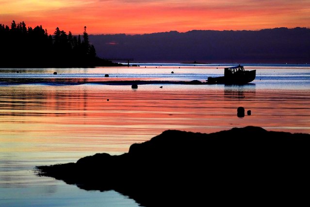 Fishermen head out to sea at dawn, Monday, October 21, 2024, in Northeast Harbor, Maine. (Photo by Robert F. Bukaty/AP Photo)