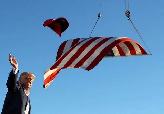Former U.S. President Donald Trump throws “Save America” hats during a rally ahead of the midterm elections, in Mesa, Arizona, U.S., October 9, 2022. (Photo by Brian Snyder/Reuters)