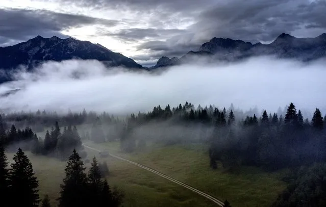 Fog lies over the valley where Elmau castle is located, Klais, Germany, Saturday, June 25, 2022. The G7 summit will start on Sunday. (Photo by Michael Probst/AP Photo)