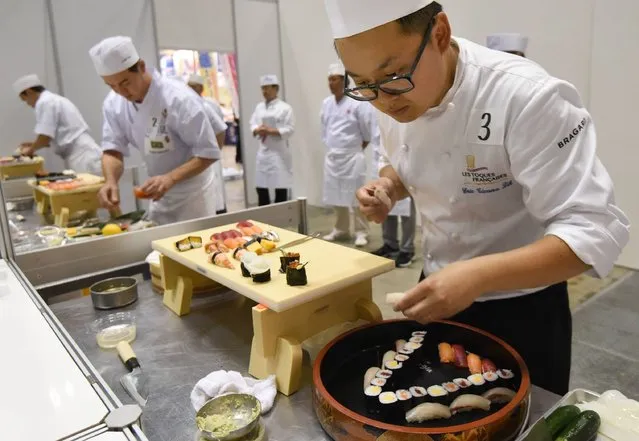 Eric Ticana Sik (R) of France and other young foreign sushi chefs make sushi at the World Sushi Cup Japan 2016 in Tokyo on August 18, 2016. Twenty-seven sushi chefs from fourteen countries and two regions took part in the two-day competition in hygienic and technical skill of sushi making organized by Japan's Agriculture, Forestry and Fisheries Ministry. (Photo by Toru Yamanaka/AFP Photo)
