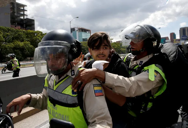 A protester (C) is detained during a rally to demand a referendum to remove Venezuela's President Nicolas Maduro in Caracas, Venezuela, September 1, 2016. (Photo by Carlos Garcia Rawlins/Reuters)