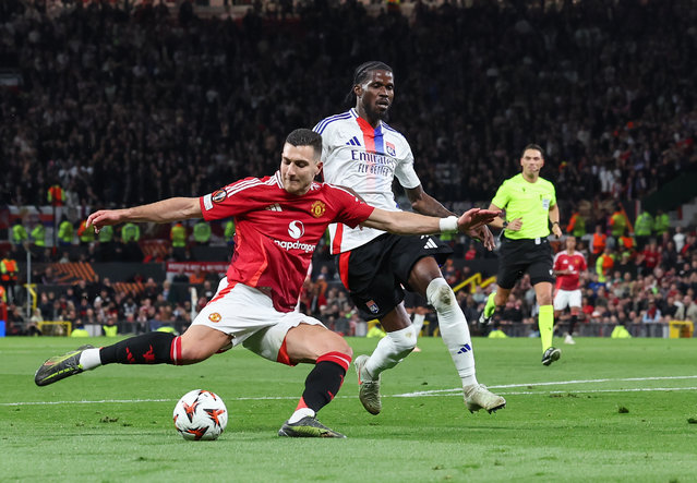 Manchester United's Diogo Dalot scores his side's second goal despite the attentions of Lyon's Paul Akouokou during the UEFA Europa League 2024/25 Quarter Final Second Leg match between Manchester United and Olympique Lyonnais at Old Trafford on April 17, 2025 in Manchester, England. (Photo by Alex Dodd - CameraSport via Getty Images)