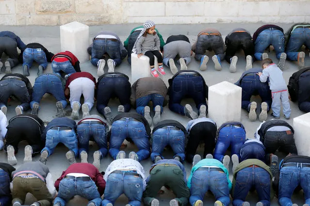 Palestinians pray before the funeral of Bassel Mustafa Ibrahim in the village of Anata, on the edge of Jerusalem December 16, 2017. (Photo by Ammar Awad/Reuters)