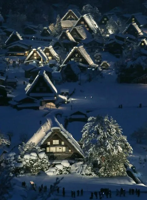 Japanese traditional wooden houses “Gassho zukuri”, are lit up in the snow-covered village of Shirakawa in Gifu prefecture, central Japan on January 19, 2013. The Gassho zukuri farmhouses were listed as one of the World Heritage by UNESCO in 1995, and the village will be illuminated until February 16. (Photo by JiJi Press/AFP Photo)