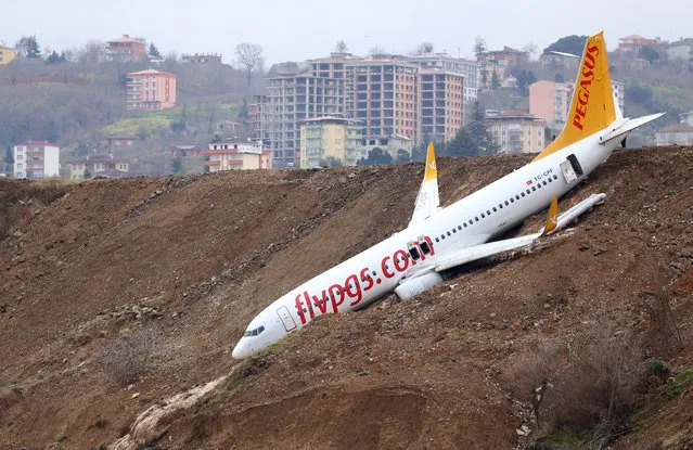 A Pegasus airplane is seen stuck in mud as it skidded off the runway after landing in Trabzon Airport, Turkey early Sunday on January 14, 2018. (Photo by Hakan Burak Altunoz/Anadolu Agency/Getty Images)