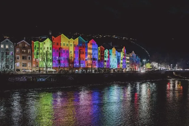 Facades of houses at Mariahilf are illuminated to celebrate the New Year 2023 in Innsbruck, Austria, on December 31, 2022. (Photo by JFK via AFP Photo)